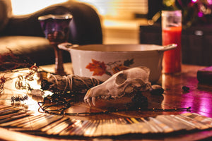 pottery, cards, herbs. candle, goblet Photo by Devin H on Unsplash